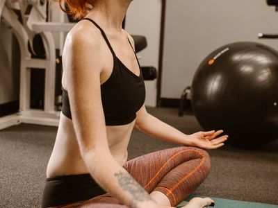 Man sitting in a calm meditative pose after a workout.
